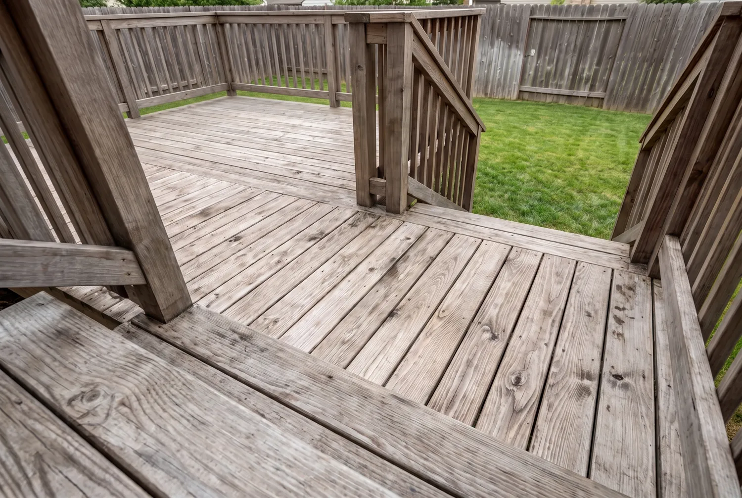 A deck before staining, weathered silver grey with splintered grain