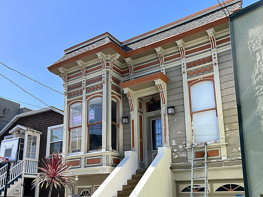 The same terracotta trimmed Victorian mid job with a ladder against the facade